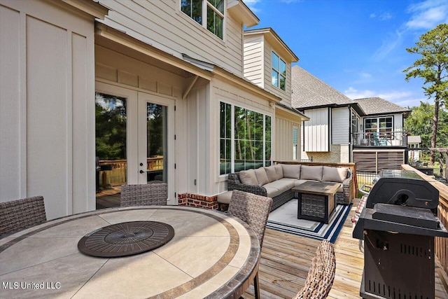 deck with an outdoor living space and a patio