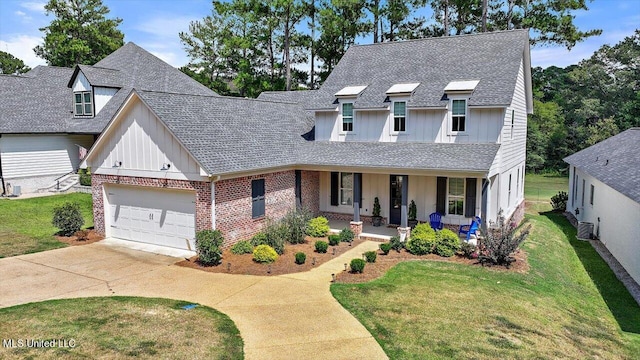 view of front facade with covered porch, a garage, and a front lawn