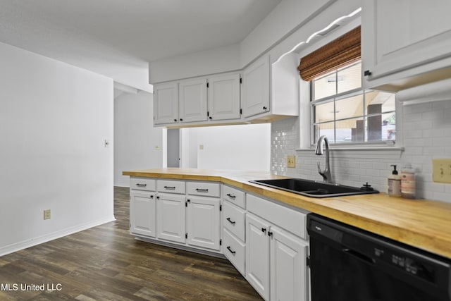 kitchen featuring white cabinets, a sink, dishwasher, wooden counters, and decorative backsplash