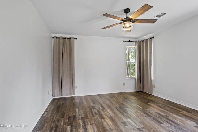 spare room featuring baseboards, a ceiling fan, wood finished floors, and visible vents
