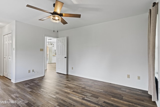 unfurnished bedroom featuring baseboards, a ceiling fan, dark wood-style flooring, and a closet