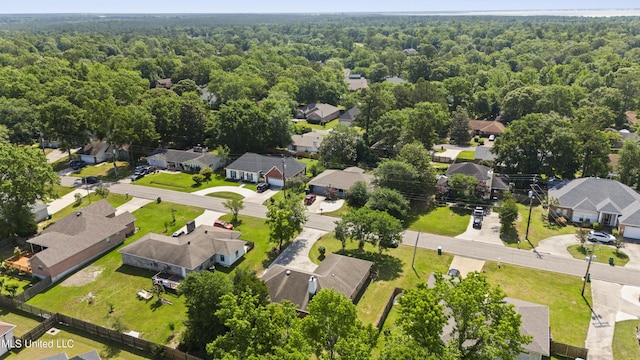 drone / aerial view featuring a view of trees and a residential view