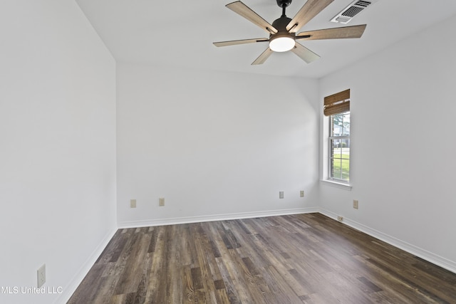 empty room with baseboards, visible vents, dark wood-style floors, and ceiling fan