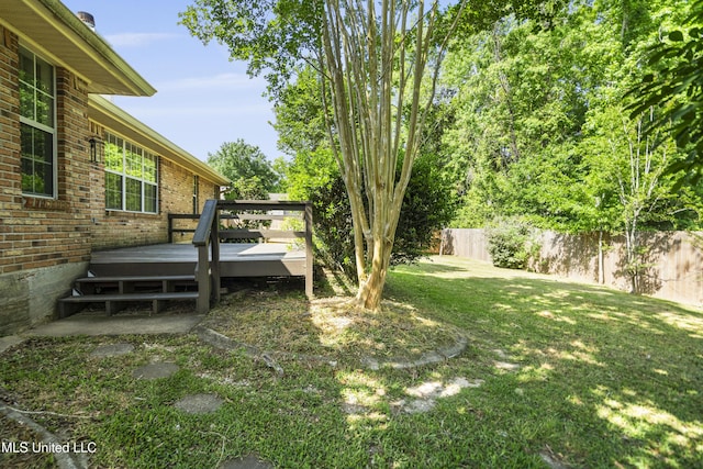 view of yard featuring a deck and fence