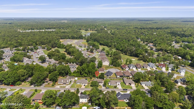 drone / aerial view featuring a residential view and a wooded view