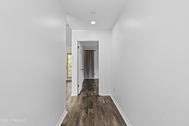 hall featuring baseboards, recessed lighting, and dark wood-style floors