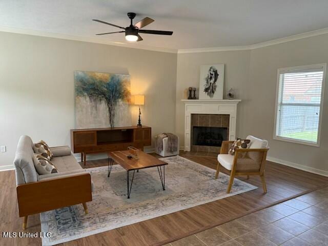 935 Frisky Dr, Brandon, MS 39047 - living area with ornamental molding, a ceiling fan, a tile fireplace, and baseboards