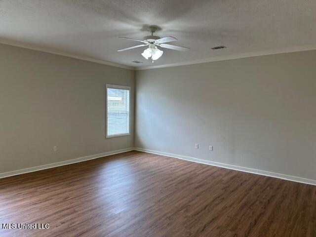 935 Frisky Dr, Brandon, MS 39047 - unfurnished room with a ceiling fan, dark wood-style floors, crown molding, and baseboards