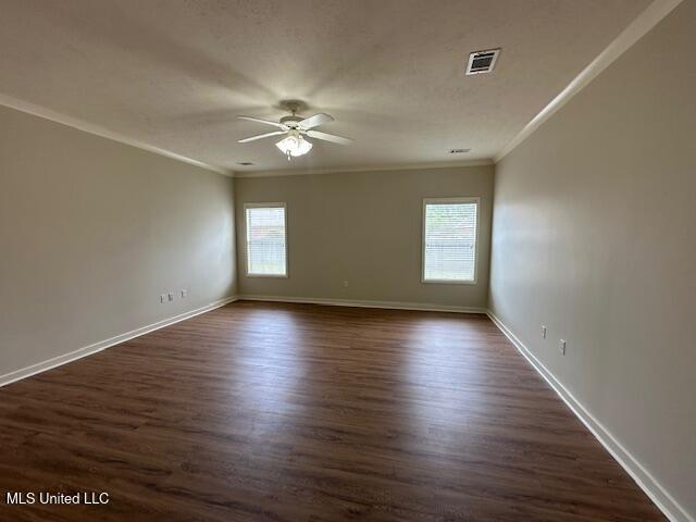 935 Frisky Dr, Brandon, MS 39047 - spare room with a ceiling fan, crown molding, baseboards, and dark wood-type flooring
