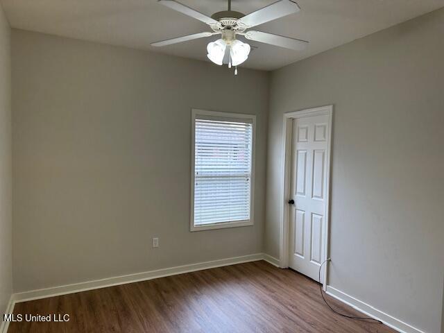 935 Frisky Dr, Brandon, MS 39047 - empty room with wood finished floors, baseboards, and ceiling fan