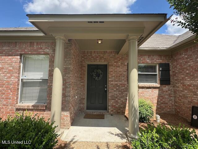 935 Frisky Dr, Brandon, MS 39047 - doorway to property featuring brick siding