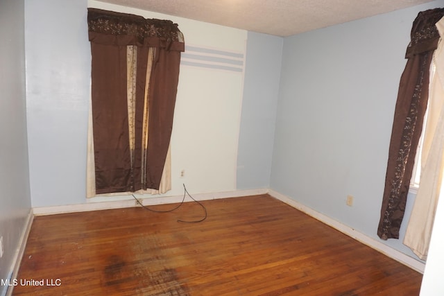 3828 California Ave, Jackson, MS 39213 - unfurnished room featuring wood finished floors, baseboards, and a textured ceiling