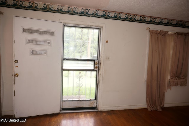 3828 California Ave, Jackson, MS 39213 - entryway featuring wood finished floors, a textured ceiling, and baseboards