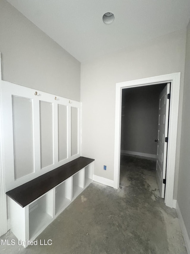 mudroom with concrete floors and baseboards