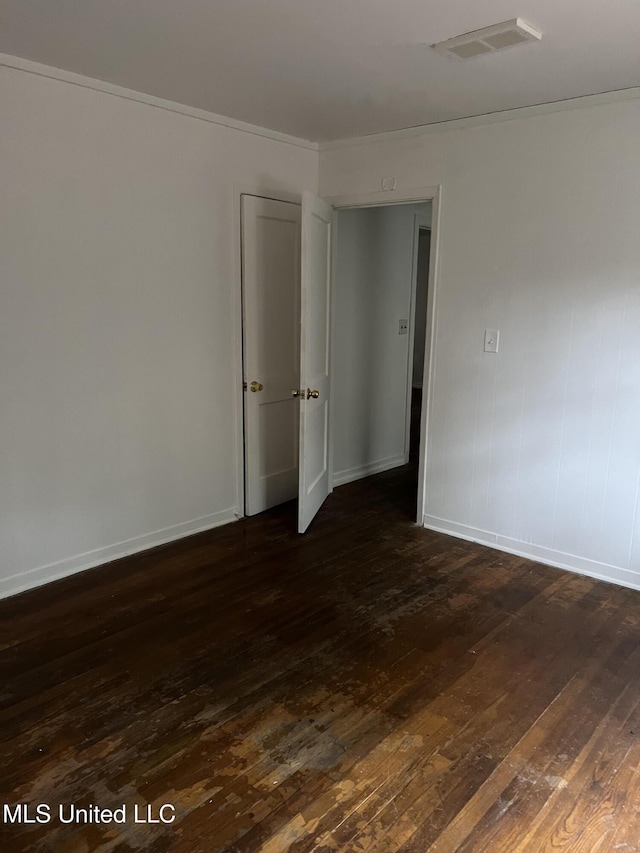 2643 Pinebrook Dr, Jackson, MS 39212 - spare room featuring dark wood-style flooring, baseboards, and ornamental molding