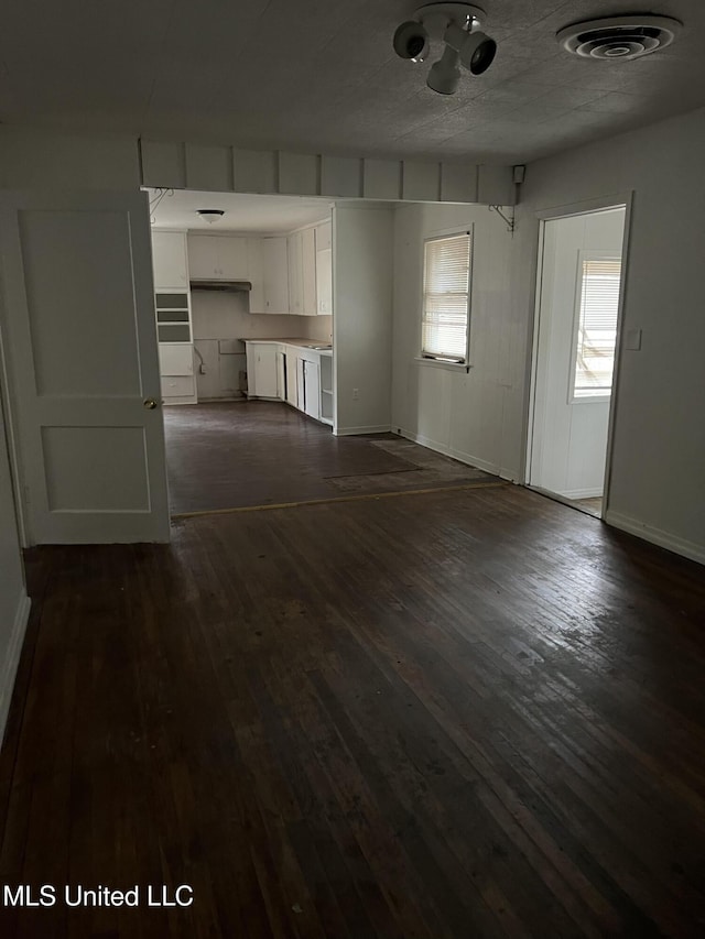 2643 Pinebrook Dr, Jackson, MS 39212 - unfurnished living room featuring dark wood finished floors and baseboards
