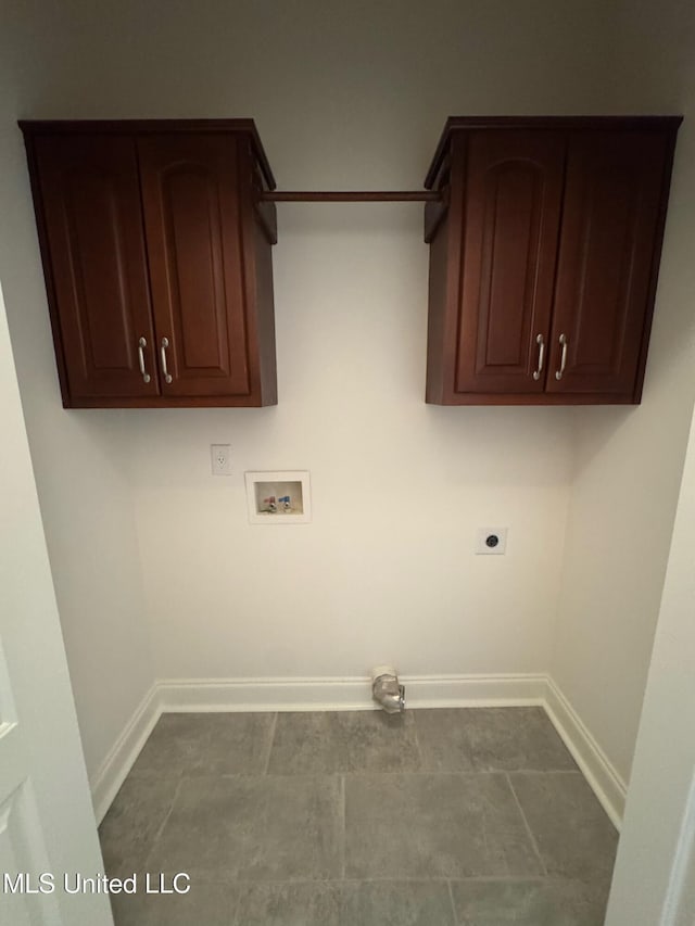 clothes washing area featuring baseboards, hookup for a washing machine, cabinet space, and hookup for an electric dryer