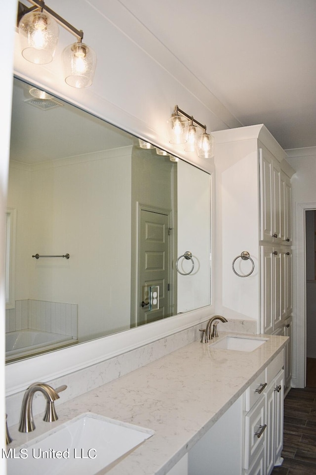 bathroom with vanity and hardwood / wood-style floors