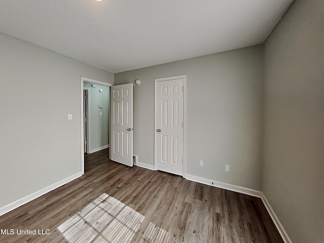 1764 Dorchester Dr, Southaven, MS 38671 - unfurnished bedroom featuring wood finished floors, baseboards, and a closet