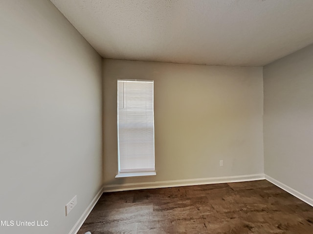 1764 Dorchester Dr, Southaven, MS 38671 - unfurnished room featuring baseboards and dark wood-style flooring