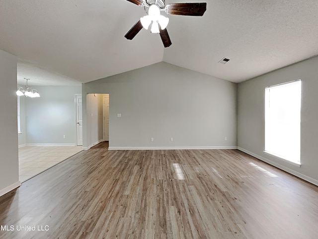 1764 Dorchester Dr, Southaven, MS 38671 - unfurnished living room featuring a ceiling fan, a chandelier, vaulted ceiling, baseboards, and light wood finished floors