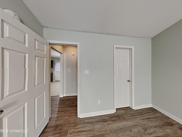 1764 Dorchester Dr, Southaven, MS 38671 - unfurnished bedroom with wood finished floors, a textured ceiling, and baseboards