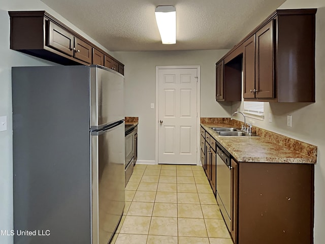 1764 Dorchester Dr, Southaven, MS 38671 - kitchen with a sink, appliances with stainless steel finishes, a textured ceiling, dark brown cabinetry, and light tile patterned floors