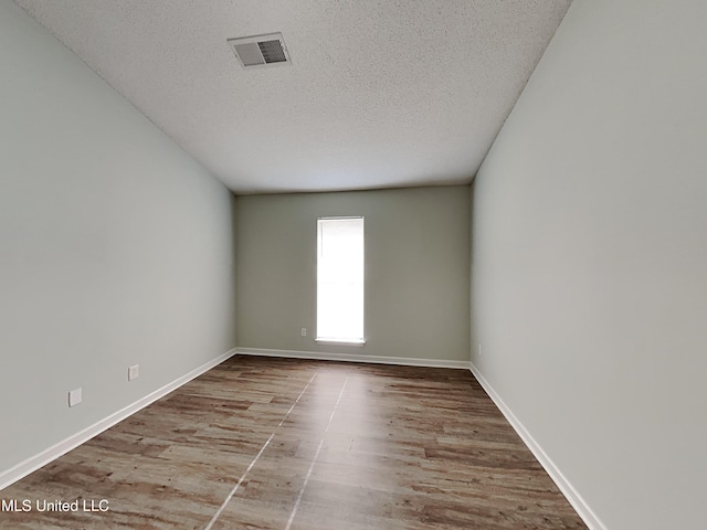 1764 Dorchester Dr, Southaven, MS 38671 - empty room with wood finished floors, a textured ceiling, and baseboards