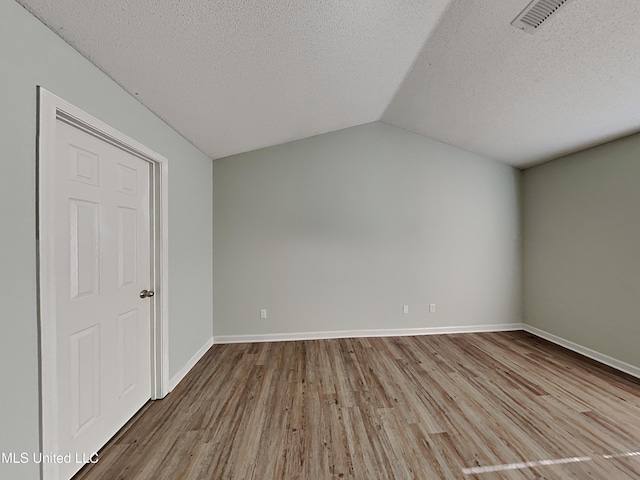 1764 Dorchester Dr, Southaven, MS 38671 - bonus room with a textured ceiling, wood finished floors, vaulted ceiling, and baseboards