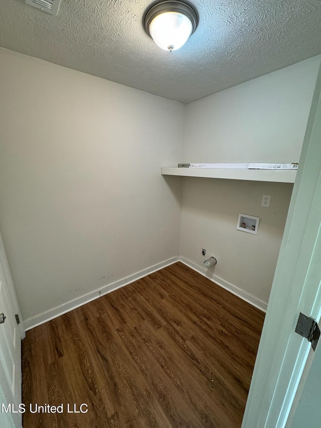 laundry area with dark wood-type flooring, a textured ceiling, gas dryer hookup, and hookup for a washing machine