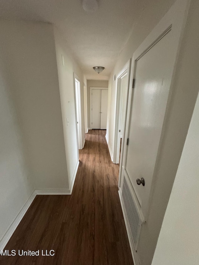 hallway featuring dark hardwood / wood-style floors