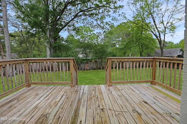 deck featuring fence private yard and a lawn