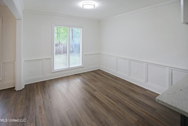 unfurnished room with dark wood-type flooring, a textured ceiling, and ornamental molding