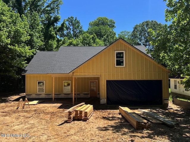 7356 Mockingbird Ln, Olive Branch, MS 38654 - view of front facade with board and batten siding, roof with shingles, and a garage