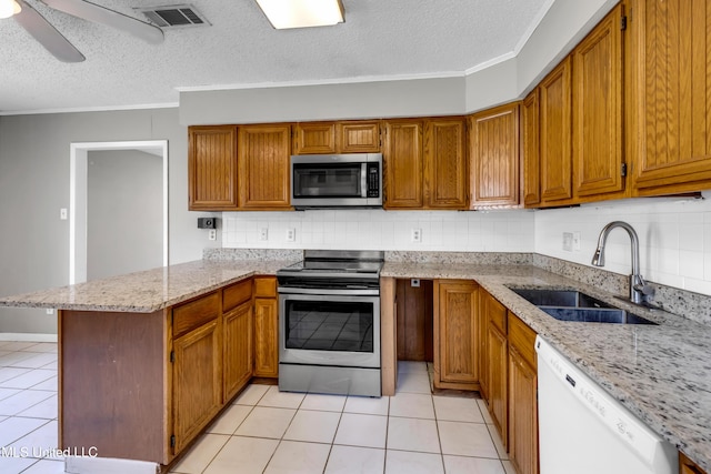 7105 Mandarin Dr, Biloxi, MS 39532 - kitchen featuring stainless steel appliances, a peninsula, crown molding, light tile patterned flooring, and a textured ceiling