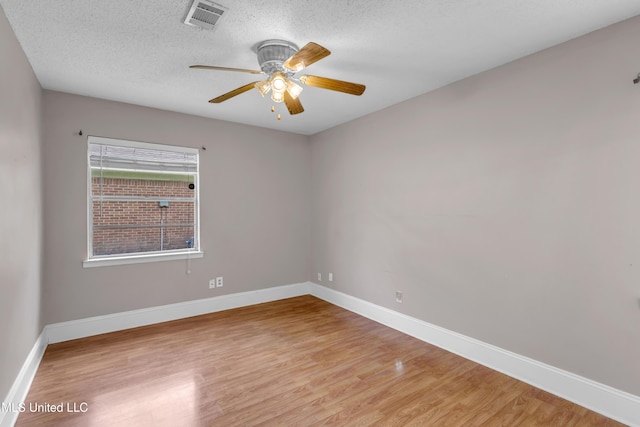 7105 Mandarin Dr, Biloxi, MS 39532 - unfurnished room with light wood-style flooring, ceiling fan, and a textured ceiling