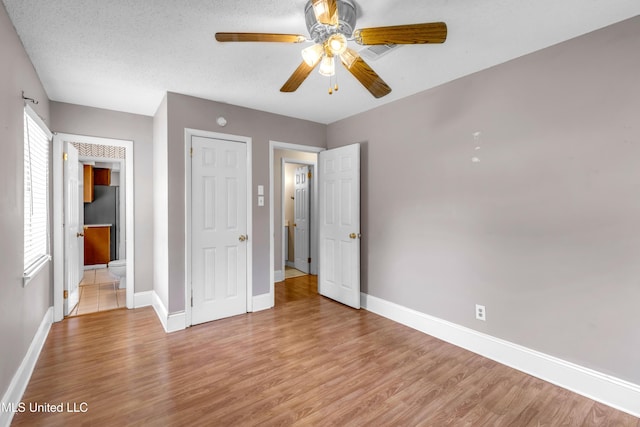 7105 Mandarin Dr, Biloxi, MS 39532 - unfurnished bedroom with light wood finished floors, multiple windows, and a ceiling fan