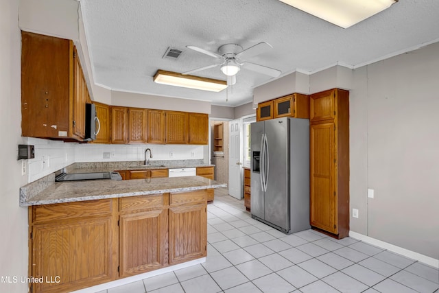 7105 Mandarin Dr, Biloxi, MS 39532 - kitchen with stainless steel appliances, a peninsula, ceiling fan, a textured ceiling, and brown cabinetry