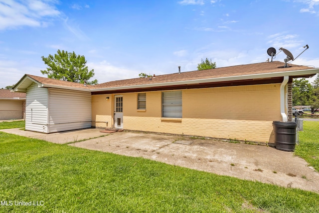 7105 Mandarin Dr, Biloxi, MS 39532 - rear view of property featuring a patio area, brick siding, and a lawn