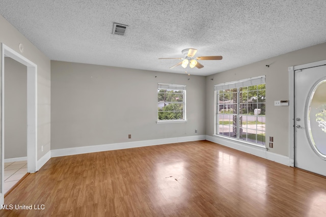 7105 Mandarin Dr, Biloxi, MS 39532 - entrance foyer featuring a ceiling fan, light wood-style floors, and a textured ceiling