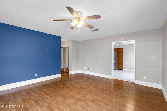 7105 Mandarin Dr, Biloxi, MS 39532 - empty room featuring a ceiling fan, a textured ceiling, and light wood finished floors