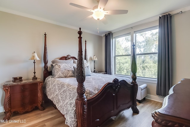 bedroom featuring ceiling fan, crown molding, and wood-type flooring