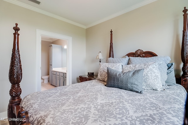 bedroom with crown molding and connected bathroom