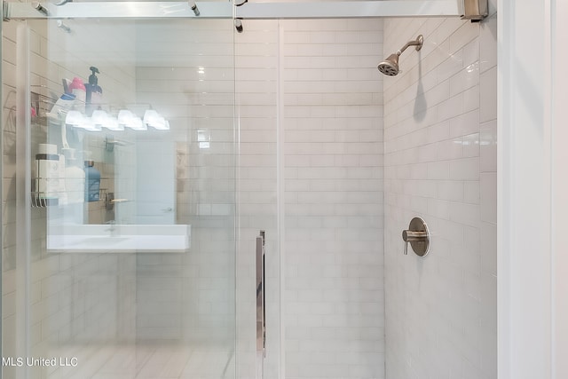 bathroom featuring a shower with door