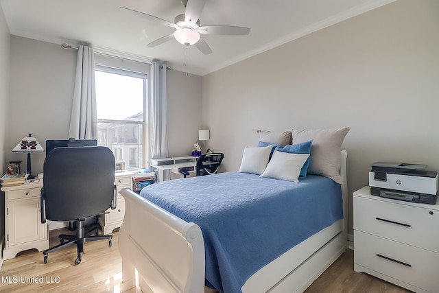 bedroom featuring ceiling fan, wood-type flooring, and crown molding