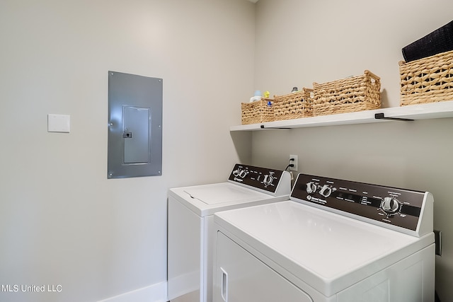 clothes washing area with electric panel and separate washer and dryer