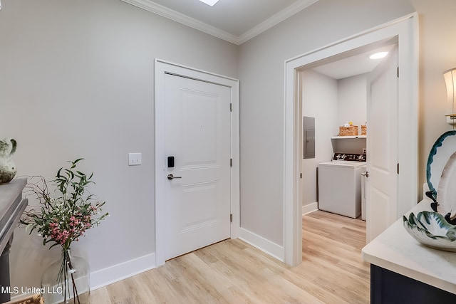 interior space with washer and dryer, ornamental molding, electric panel, and light hardwood / wood-style floors