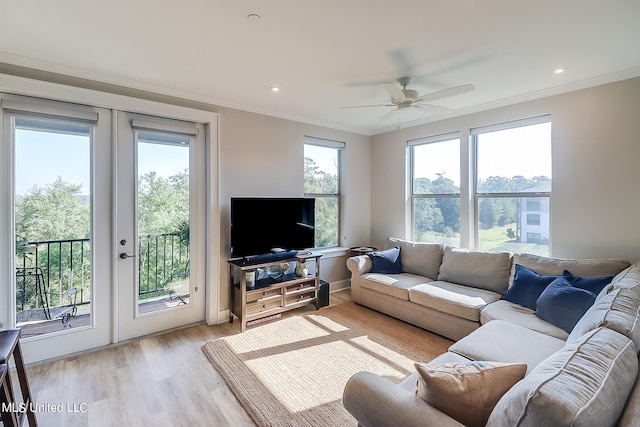 living room with ceiling fan, light hardwood / wood-style flooring, and ornamental molding