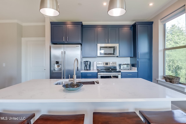 kitchen featuring light stone countertops, appliances with stainless steel finishes, a kitchen breakfast bar, sink, and pendant lighting