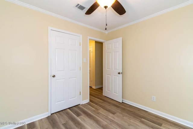 13128 Hanover Dr, Ocean Springs, MS 39564 - unfurnished bedroom with wood finished floors, crown molding, and a ceiling fan